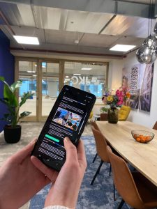 Phone in hand with a JKC newsletter open, email marketing tips from JKC