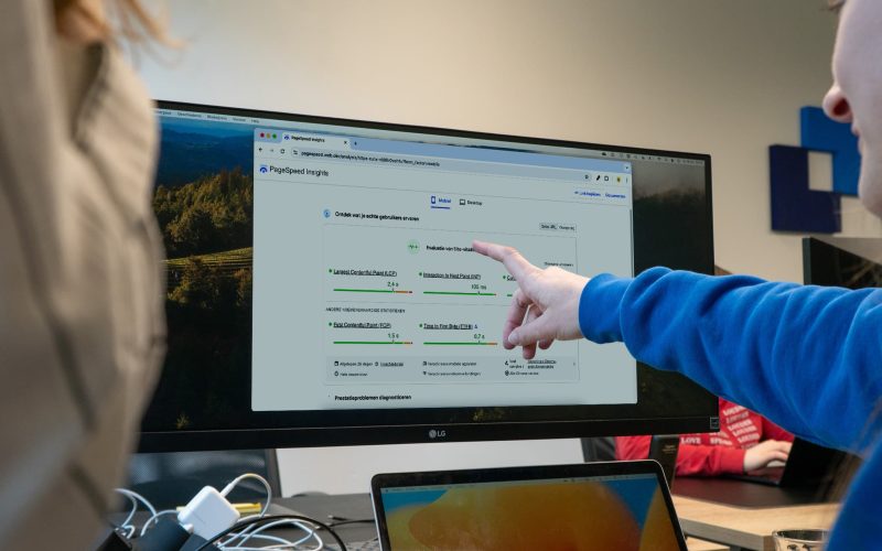 Google PageSpeed results open on a screen while JKC colleagues work together on improving website speed