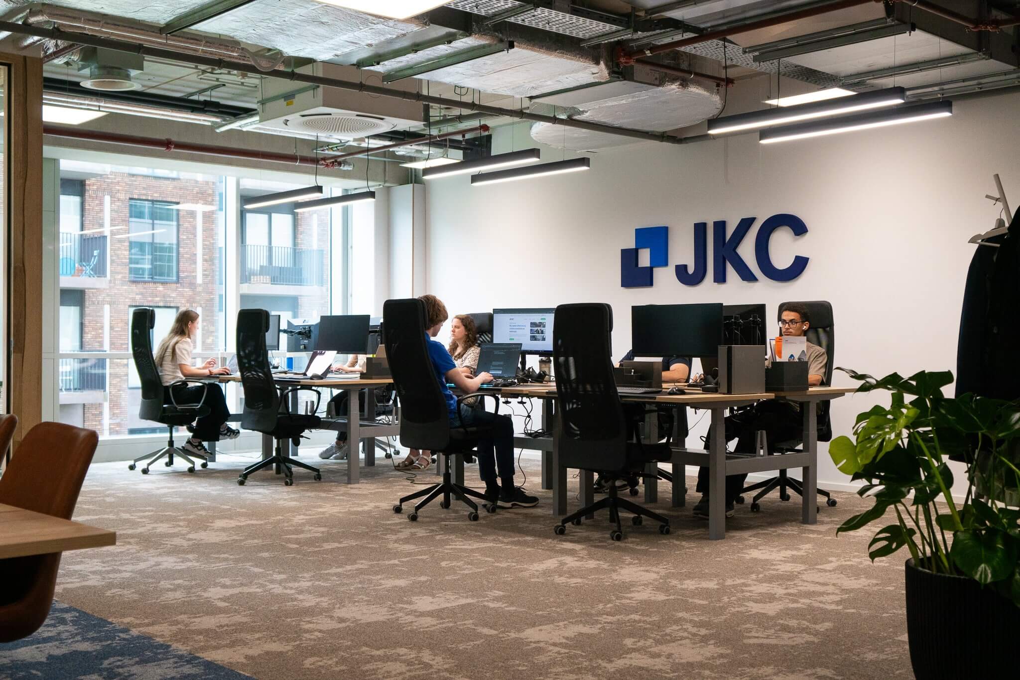 Photo of the JKC team at the office