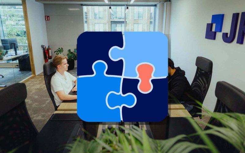 JKC colleagues at work in the office, with a large MECE puzzle icon: organizing website structure for people and AI