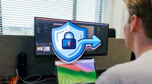 Workstation with multiple screens at JKC Media, with a large shield and lock icon: WordPress security and information security