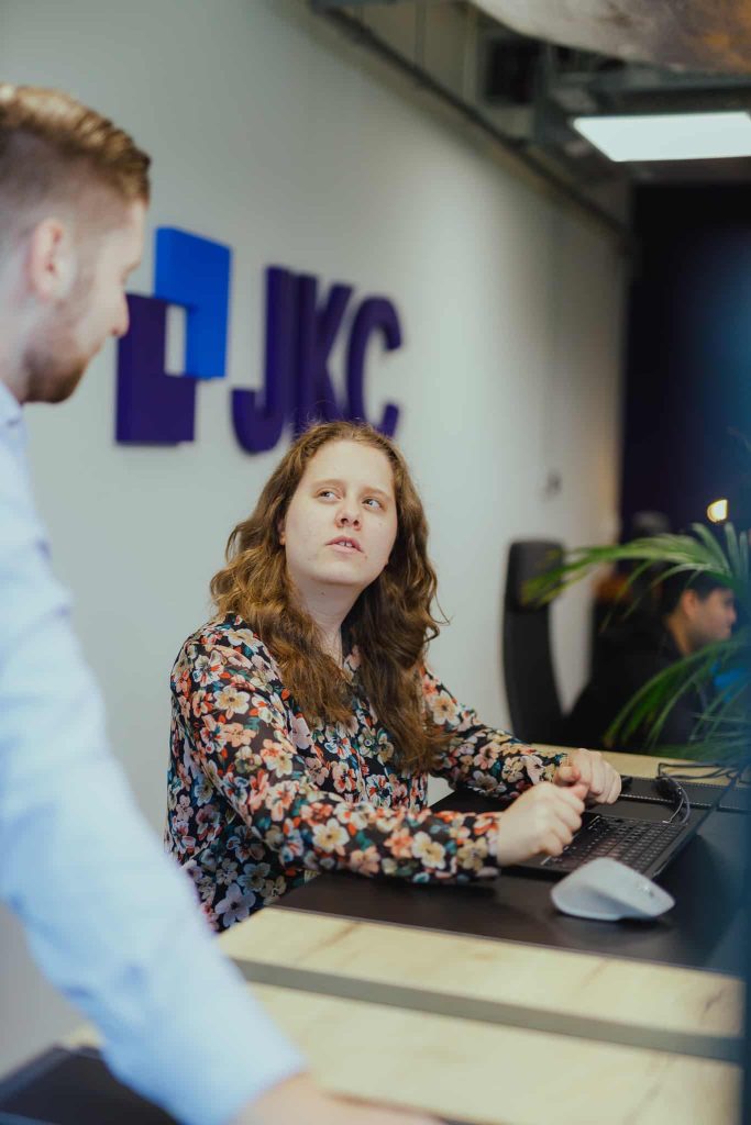 Two colleagues going through an automation together at a workstation