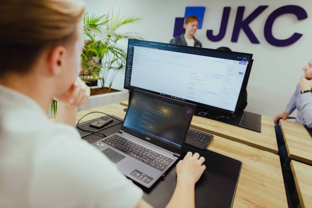 A colleague reviewing a website on a laptop at a desk