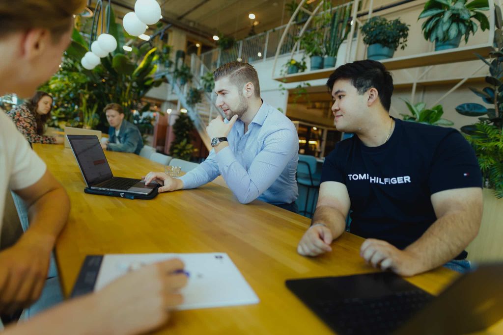 Two colleagues going through a positioning at the long table