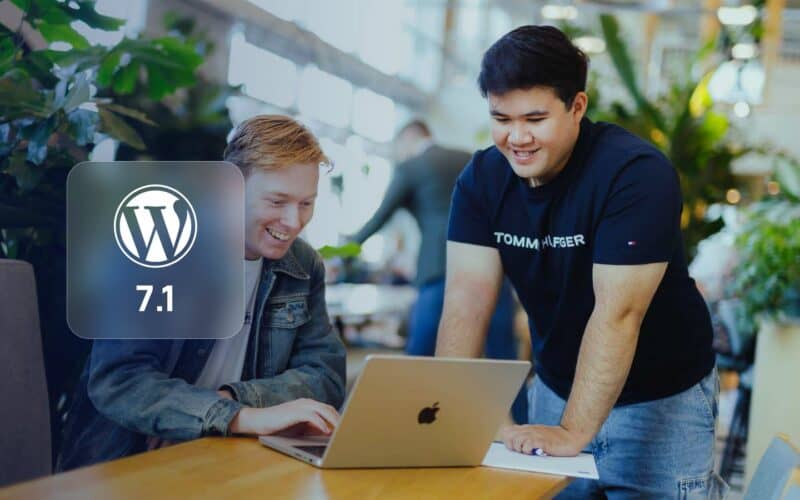 WordPress 7: two JKC Media colleagues at a laptop with the WordPress logo and version 7.1