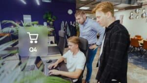 Optimise your webshop for Q4: JKC colleagues looking at a webshop together, with a shopping cart icon and the label Q4